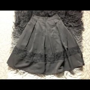 Black Poliester skirt with lace detail.